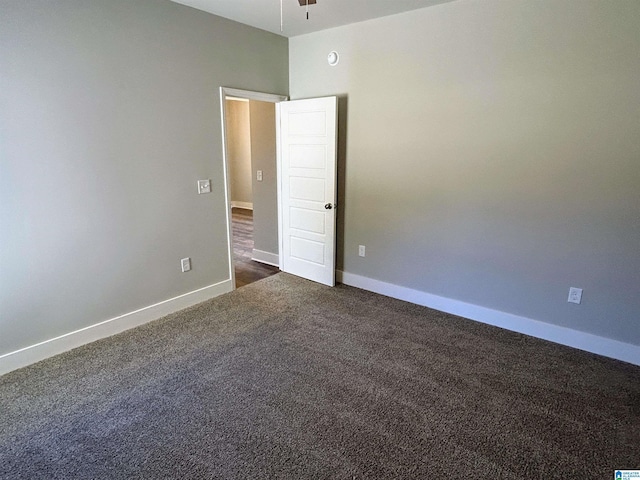 1465 Brooks Dr, Mount Olive, AL 35117 - empty room with a ceiling fan, baseboards, and dark colored carpet