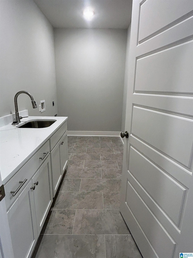 1465 Brooks Dr, Mount Olive, AL 35117 - clothes washing area with hookup for a washing machine, baseboards, cabinet space, electric dryer hookup, and a sink