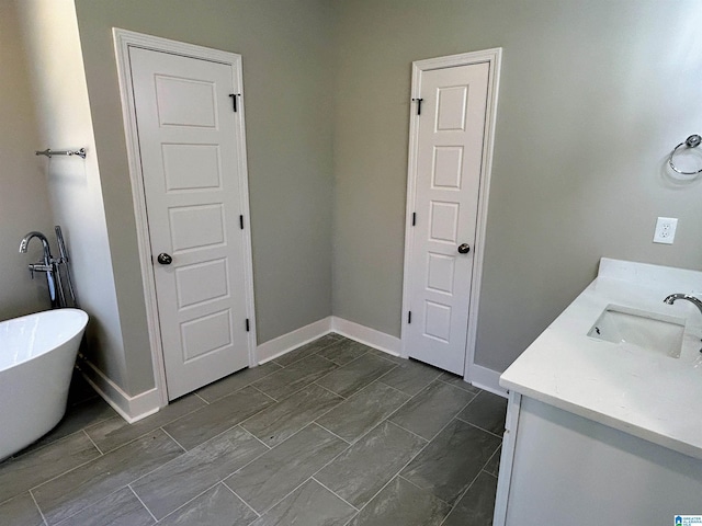 1465 Brooks Dr, Mount Olive, AL 35117 - bathroom with baseboards, a freestanding bath, and vanity