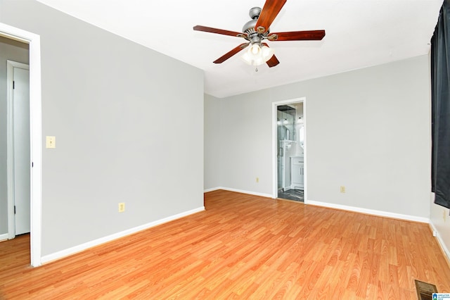 empty room with light wood-type flooring, ceiling fan, and baseboards