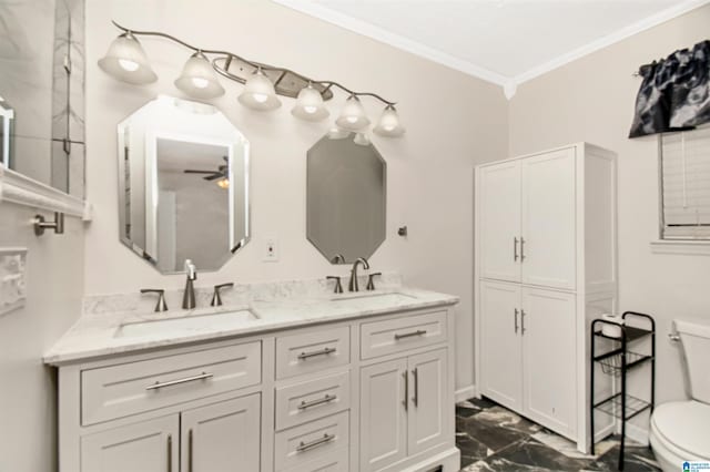 bathroom with toilet, crown molding, double vanity, and a sink