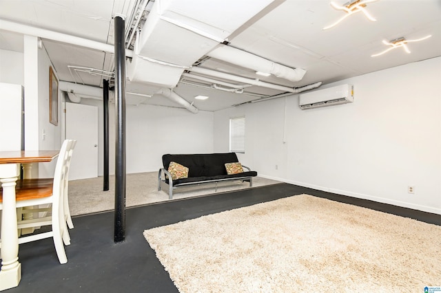 finished basement featuring a wall unit AC and baseboards