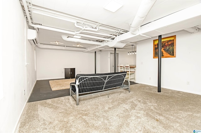 finished basement with a wall unit AC and baseboards