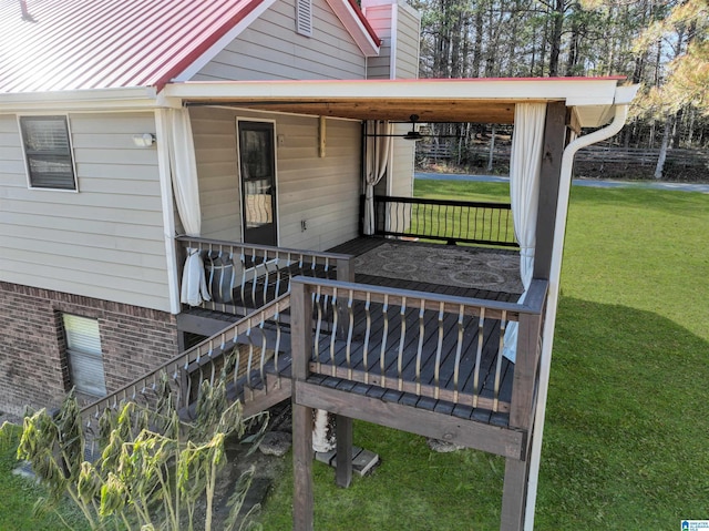 wooden terrace featuring a yard