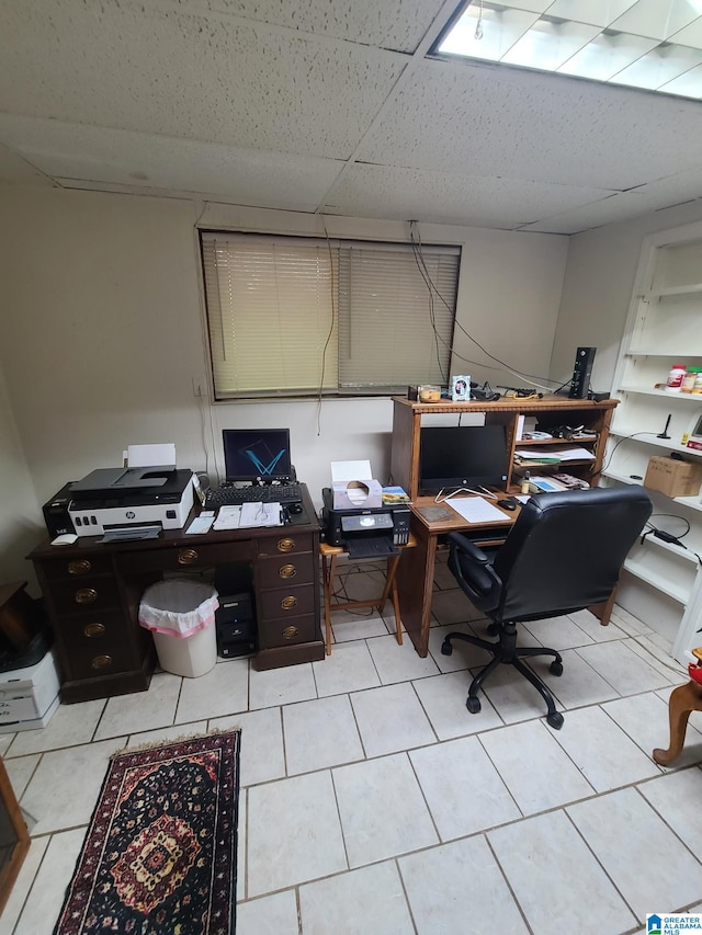 tiled office space with a drop ceiling