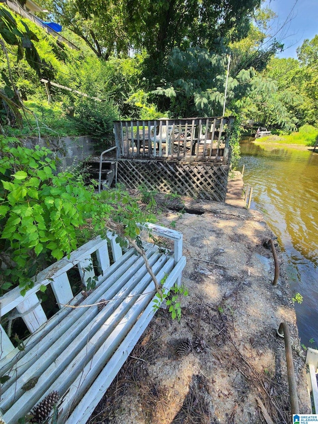 exterior space featuring a deck with water view