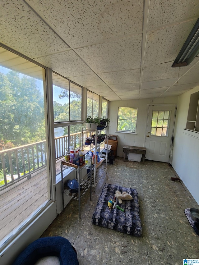 sunroom / solarium featuring a drop ceiling