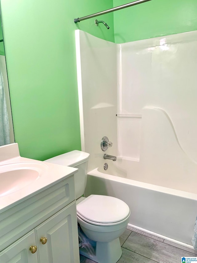 full bathroom with shower / bathing tub combination, hardwood / wood-style floors, vanity, and toilet