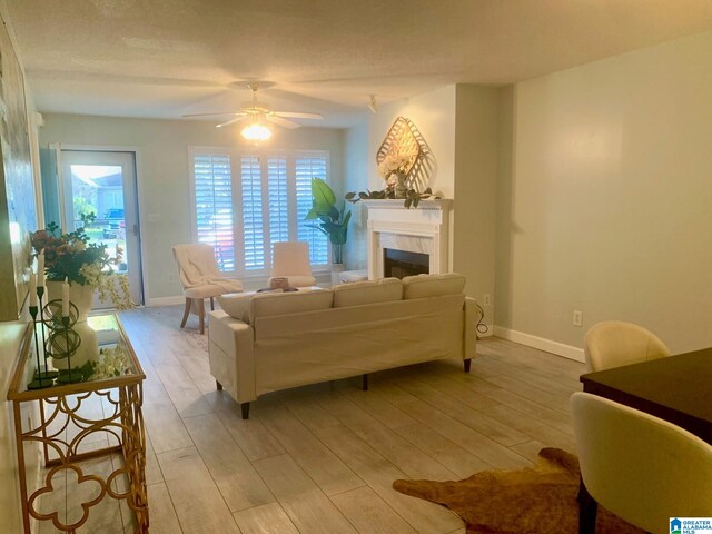 empty room with a textured ceiling, light hardwood / wood-style flooring, and ceiling fan