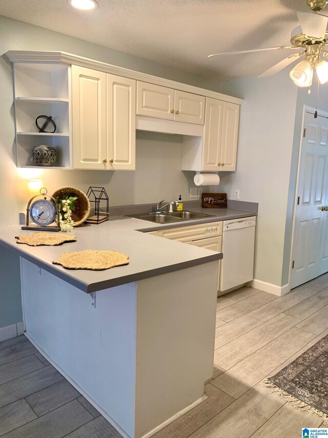 kitchen featuring light hardwood / wood-style floors, white appliances, a textured ceiling, and white cabinetry