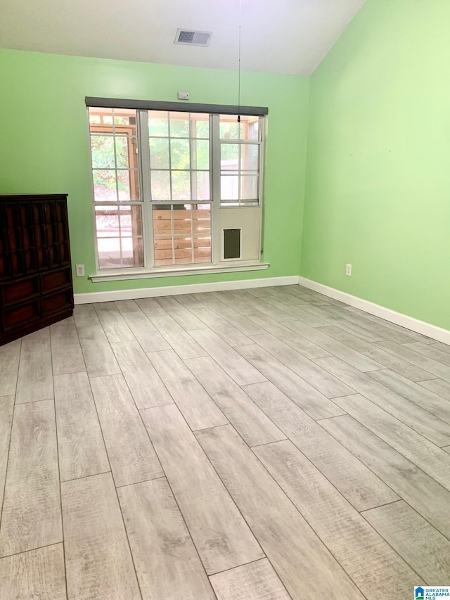 spare room featuring plenty of natural light and light hardwood / wood-style floors