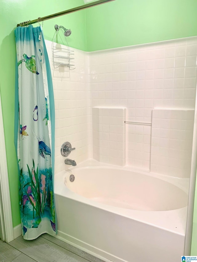 bathroom with shower / bath combo with shower curtain