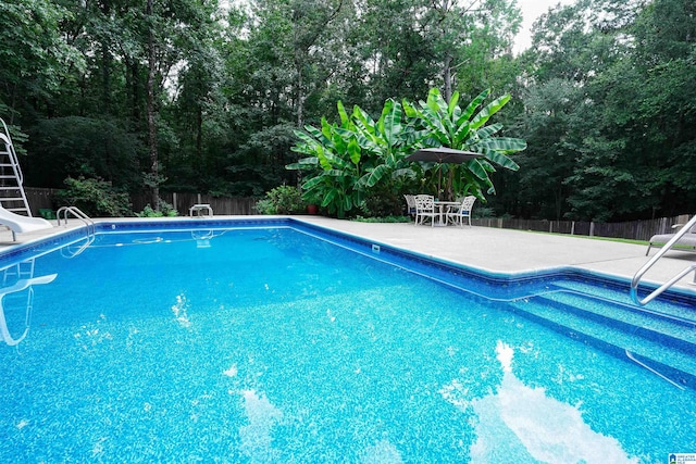 view of swimming pool featuring a water slide