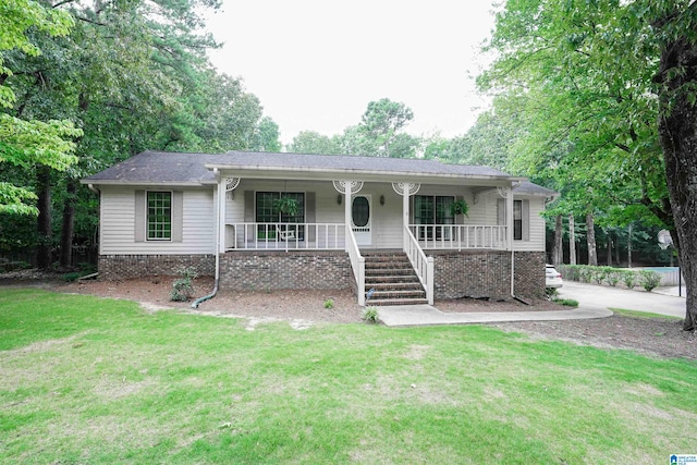 ranch-style house featuring a porch and a front lawn