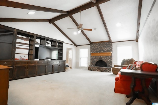 carpeted living room featuring beamed ceiling, ceiling fan, a brick fireplace, and brick wall