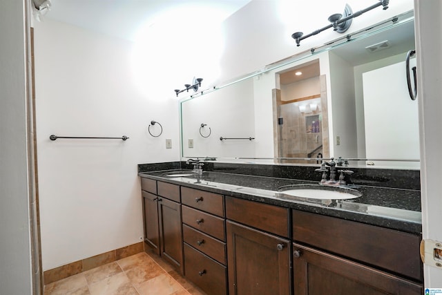 bathroom with double sink vanity and tile patterned flooring