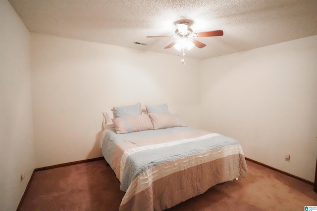 bedroom with a textured ceiling, carpet flooring, and ceiling fan