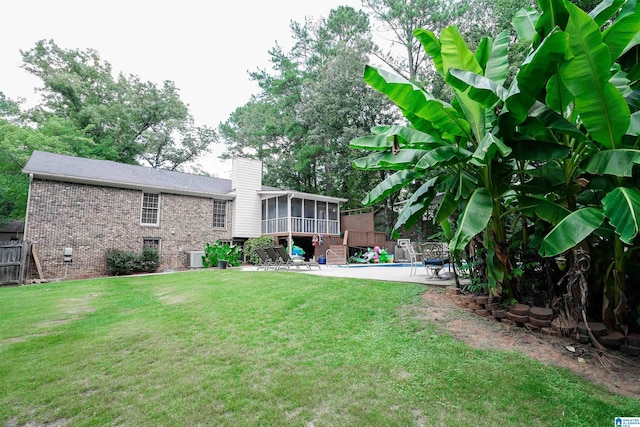 view of yard with a patio, central AC unit, and a swimming pool