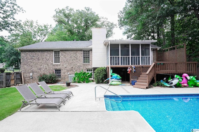 view of swimming pool featuring central AC, a sunroom, and a patio