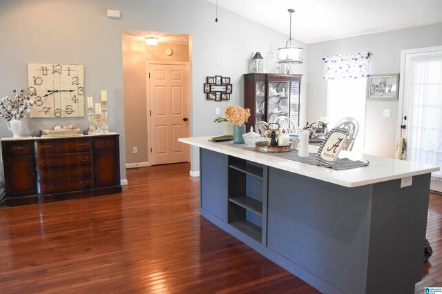 kitchen featuring dark hardwood / wood-style flooring and pendant lighting