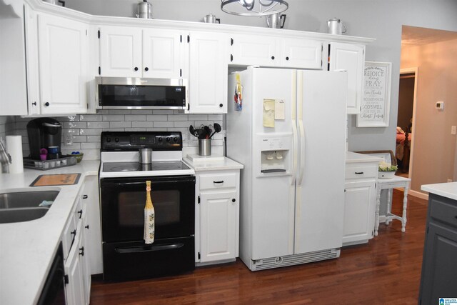 kitchen featuring dark wood-type flooring, tasteful backsplash, white cabinetry, and white appliances