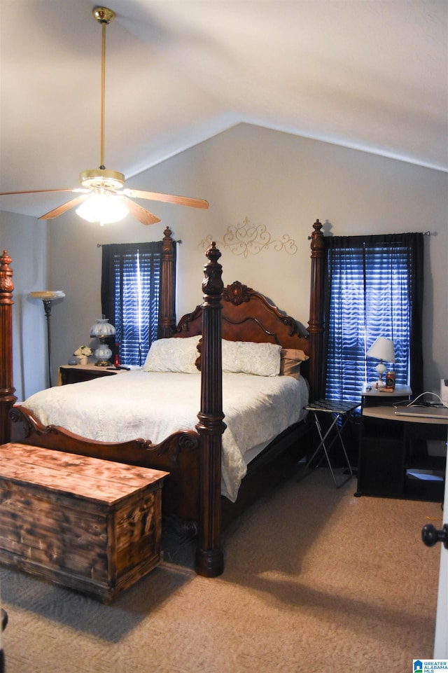 carpeted bedroom with ceiling fan and vaulted ceiling