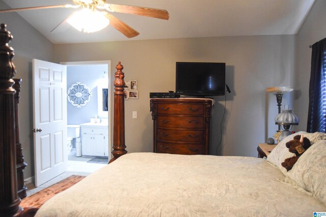 bedroom with ensuite bathroom, ceiling fan, and lofted ceiling