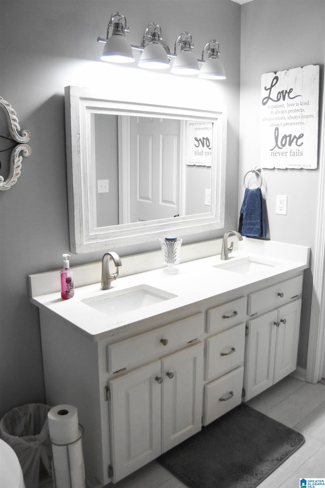 bathroom with double sink vanity and tile patterned flooring