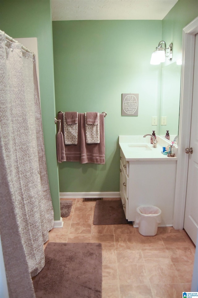 bathroom with vanity and tile patterned flooring