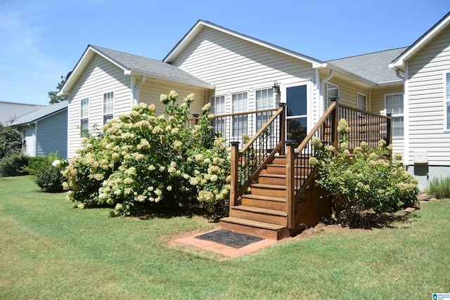 view of front facade featuring a deck and a front lawn