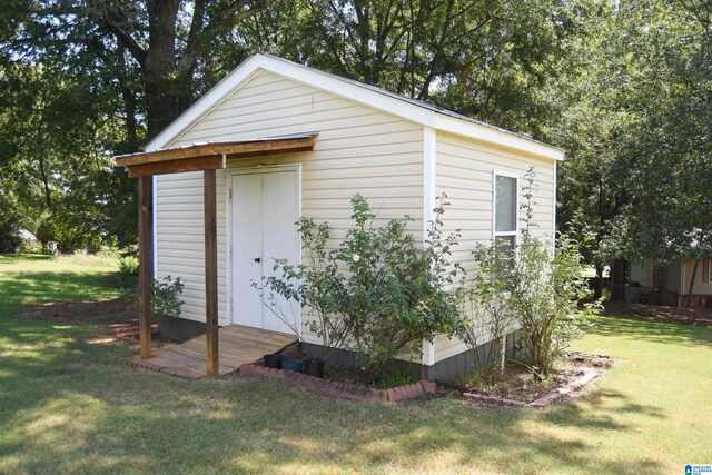 view of outbuilding with a yard