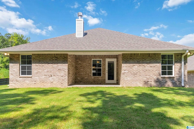 rear view of house with a lawn