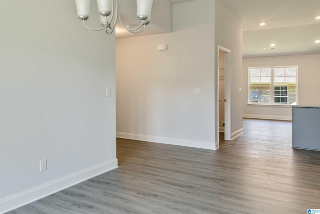 interior space with wood-type flooring and an inviting chandelier