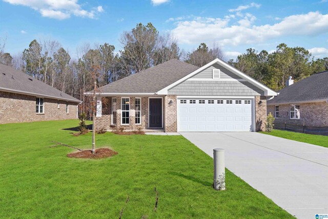 view of front of property featuring a garage and a yard