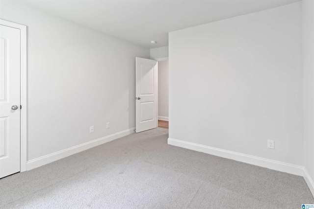 unfurnished bedroom with light colored carpet