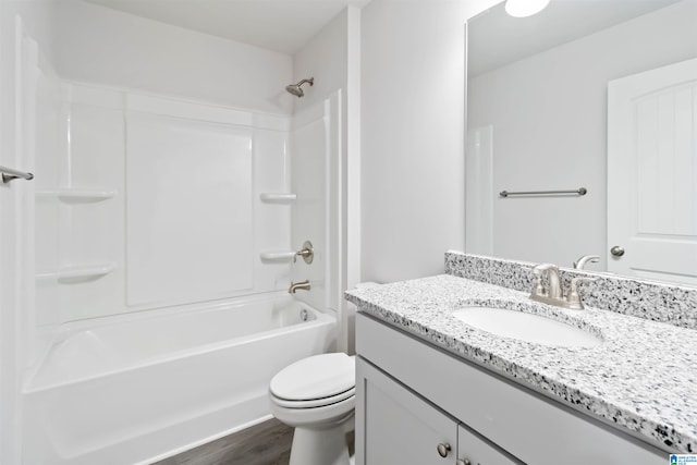 full bathroom with bathing tub / shower combination, vanity, wood-type flooring, and toilet