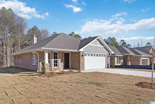 view of front of house featuring a garage and a front yard