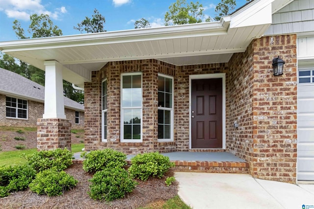 view of exterior entry with a porch