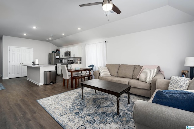 living room featuring lofted ceiling, dark hardwood / wood-style flooring, and ceiling fan