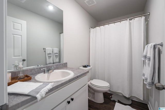 bathroom with hardwood / wood-style floors, vanity, and toilet