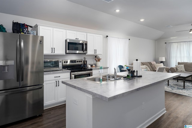 kitchen with dark wood-type flooring, a kitchen island with sink, appliances with stainless steel finishes, white cabinets, and sink