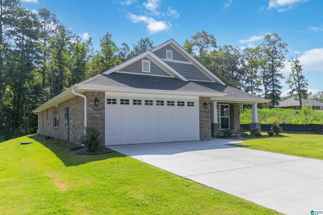 craftsman house with a front lawn and a garage