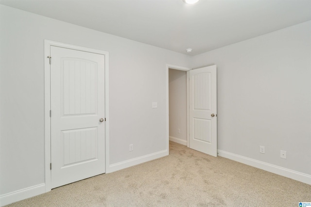 unfurnished bedroom featuring light colored carpet