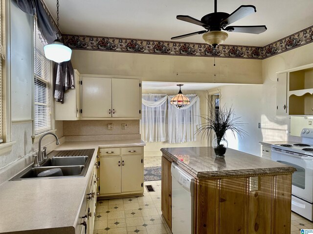 401 SW 8th St, Cullman, AL 35055 - kitchen with white appliances, a ceiling fan, light floors, a sink, and hanging light fixtures