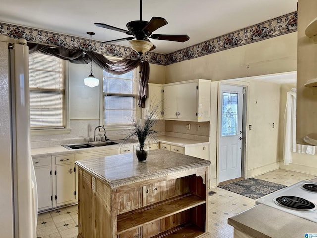 401 SW 8th St, Cullman, AL 35055 - kitchen featuring a sink, light floors, freestanding refrigerator, and open shelves
