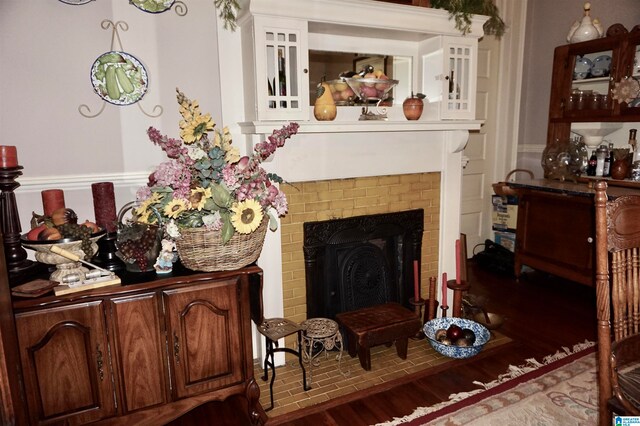 interior space featuring a brick fireplace and wood-type flooring