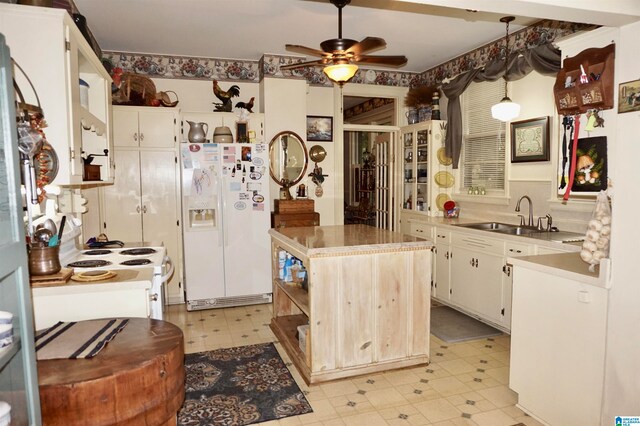 kitchen featuring pendant lighting, white appliances, light tile patterned floors, ceiling fan, and sink