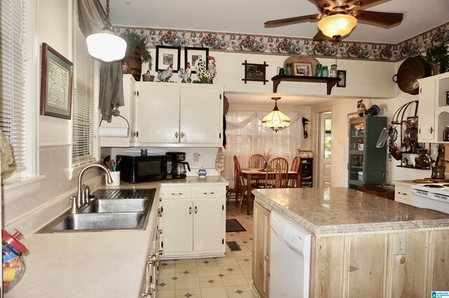 kitchen with white cabinetry, sink, white dishwasher, and light tile patterned floors