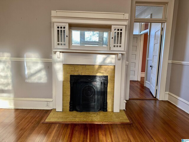 401 SW 8th St, Cullman, AL 35055 - room details featuring a fireplace with flush hearth, wood finished floors, and baseboards