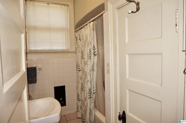 401 SW 8th St, Cullman, AL 35055 - bathroom featuring tile patterned floors, a wainscoted wall, shower / bath combo with shower curtain, a sink, and tile walls